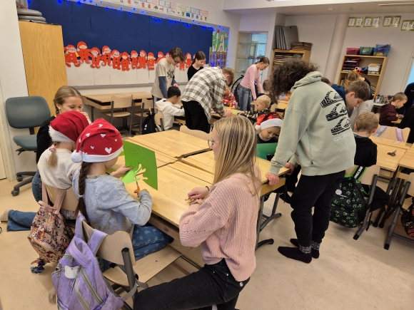 seiskaluokkalaiset auttamassa ykkösiä askartelussa